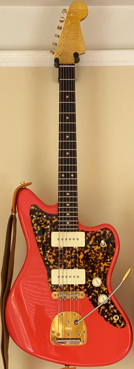 A picture of the completed Worthmaster guitar, hanging at a similar angle.